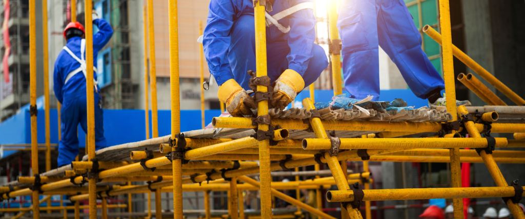 Workers putting scaffolding together 