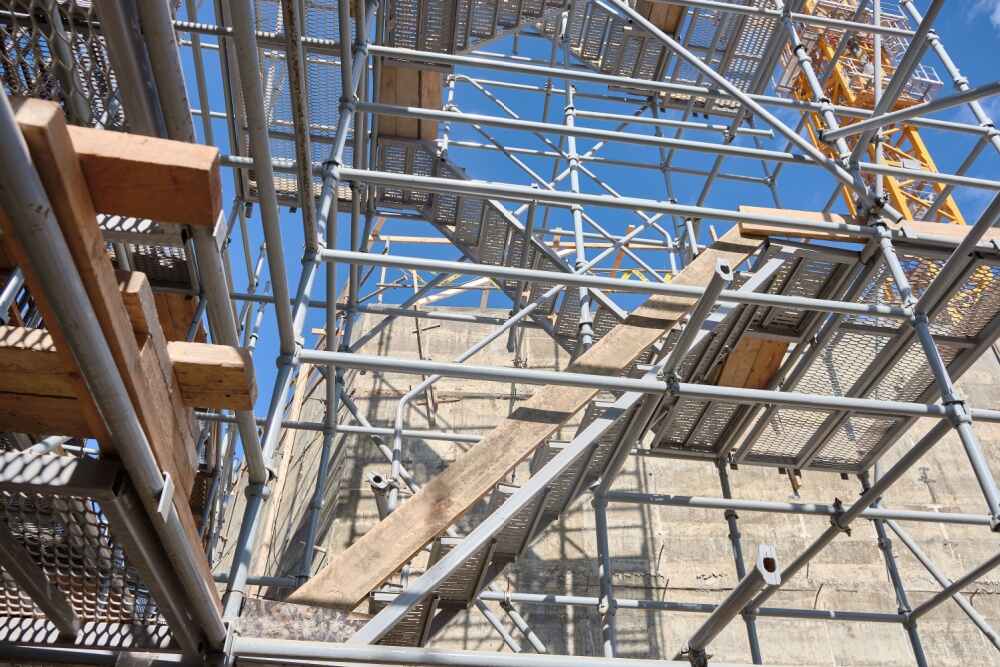 Industrial stair tower and scaffoldings at construction site.