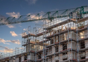 Scaffolding around the shell of an apartment building.